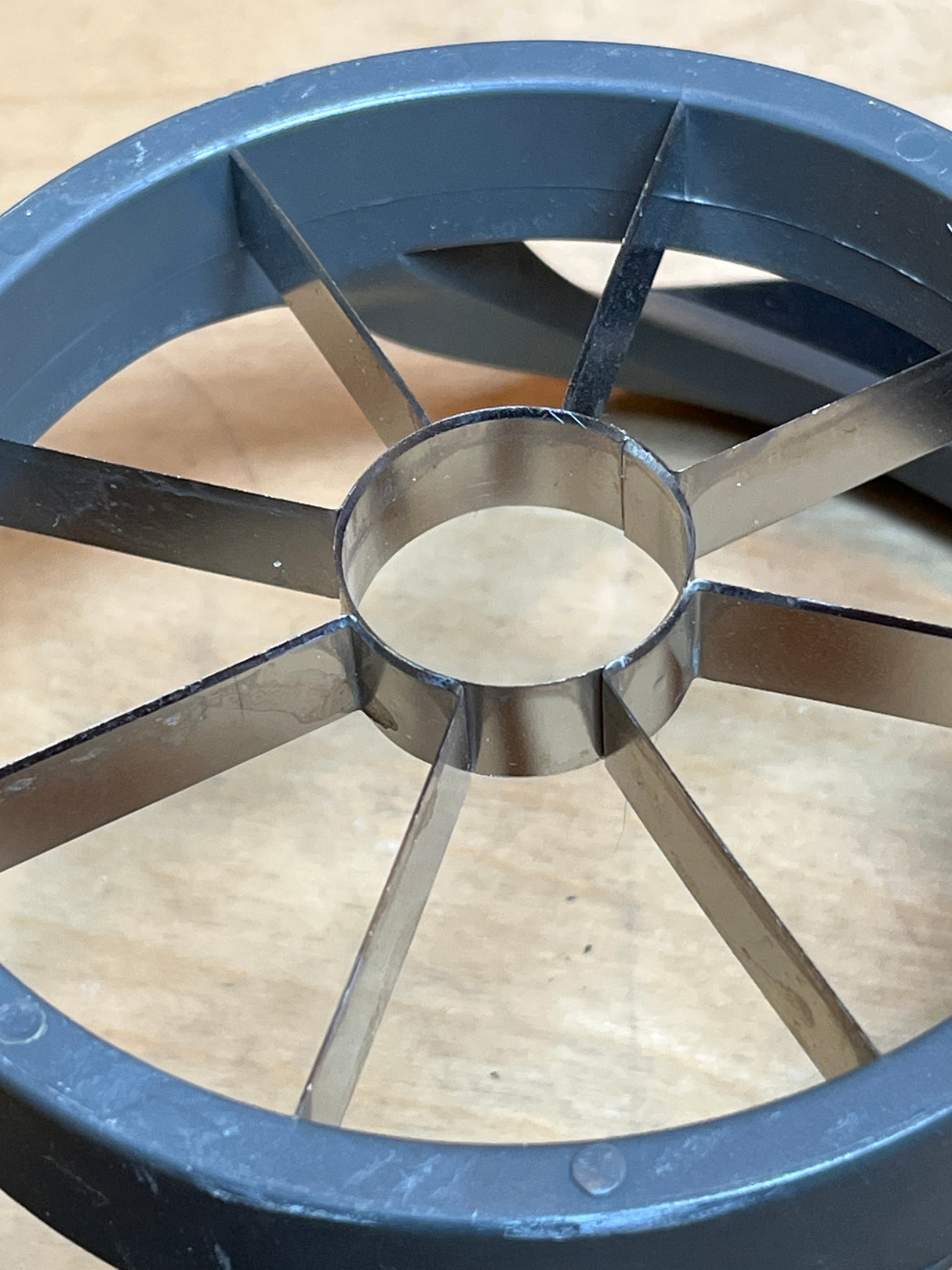 Pineapple corer - Hamilton Beach with a round plastic frame and stainless steel blades, featuring grippy silicone and plastic handles for easy coring and slicing.