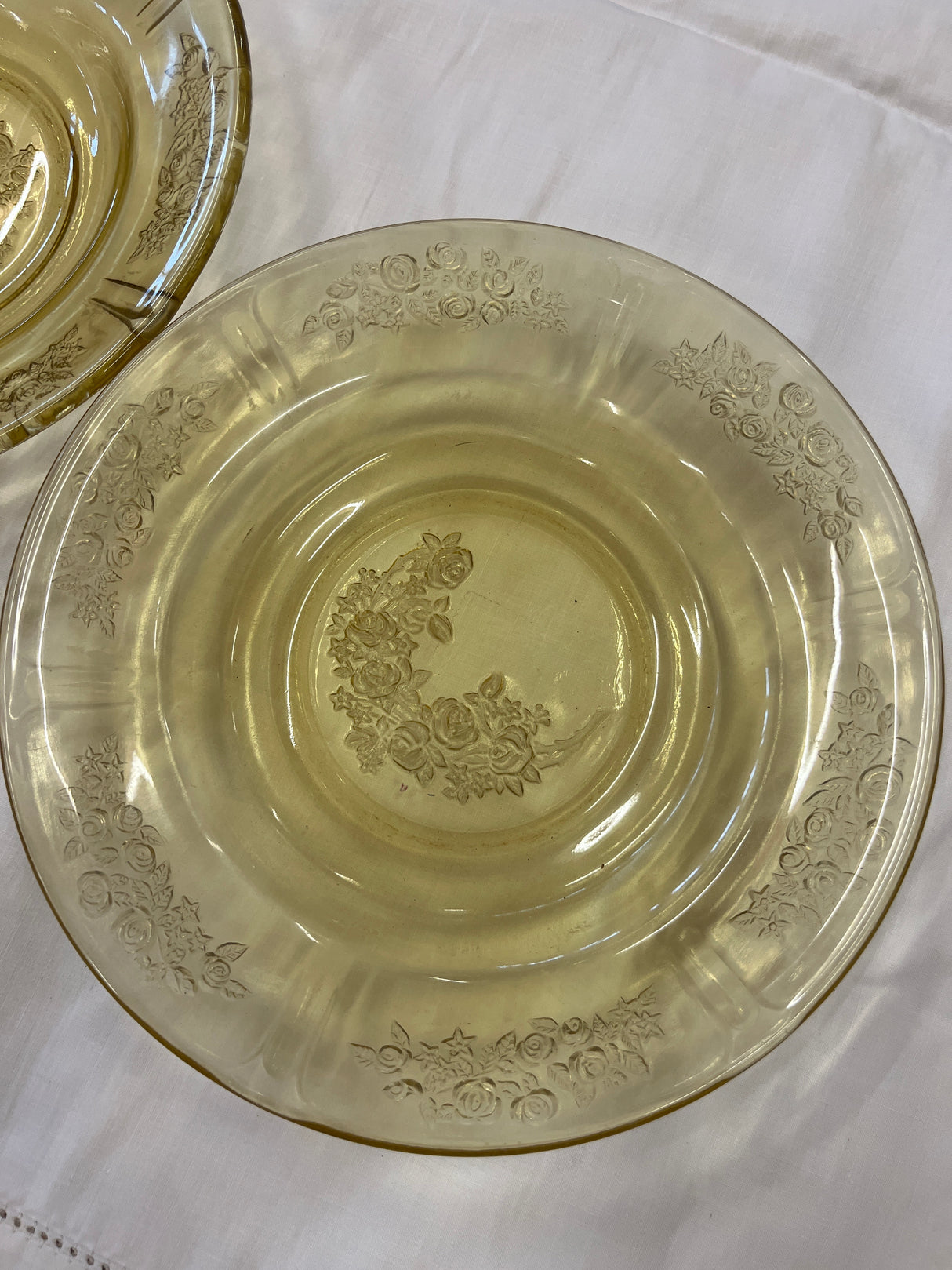 Close-up of a 1930s Federal Glass Amber Sharon/Cabbage Rose fruit bowl showcasing intricate embossed floral details, showcasing its excellent condition with minimal wear.