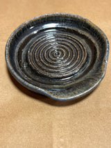 Handmade ceramic garlic grater spoon rests by Charles Lehman, featuring concentric ridges and a spout, perfect for juicing or displaying on your kitchen counter.