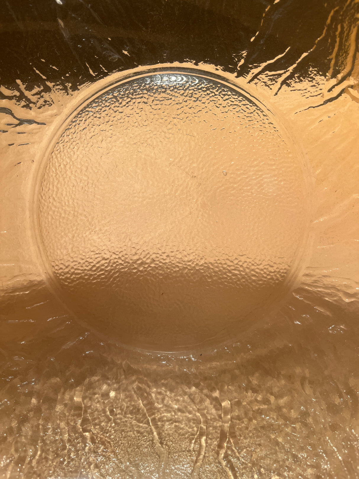 Close-up of Viking 2408 cabbage 12 glass serving bowl, showcasing its textured, amber-like surface with embossed cabbage design, capturing light beautifully.
