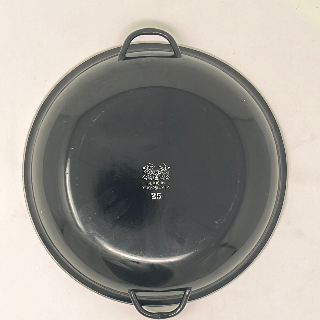 Black and red enameled steel Paella Pan with handles, showcasing bright red enamel in excellent condition, suitable for display when not in use.