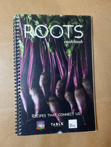Spiral-bound cookbook ROOTS with freshly harvested beets on cover, featuring the tagline Recipes That Connect Us and logos for Farm to Table, TABLE Magazine, and for good.