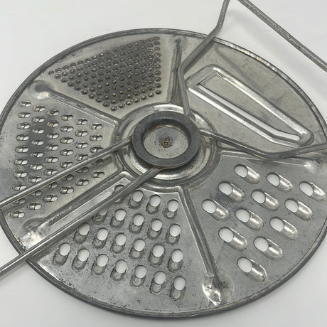 Vintage Foley Five-Setting Grater and Slicer, 1950s kitchenware. Circular metal object with holes, sharp slicer blade, surface imperfections. Rare find in good working shape.