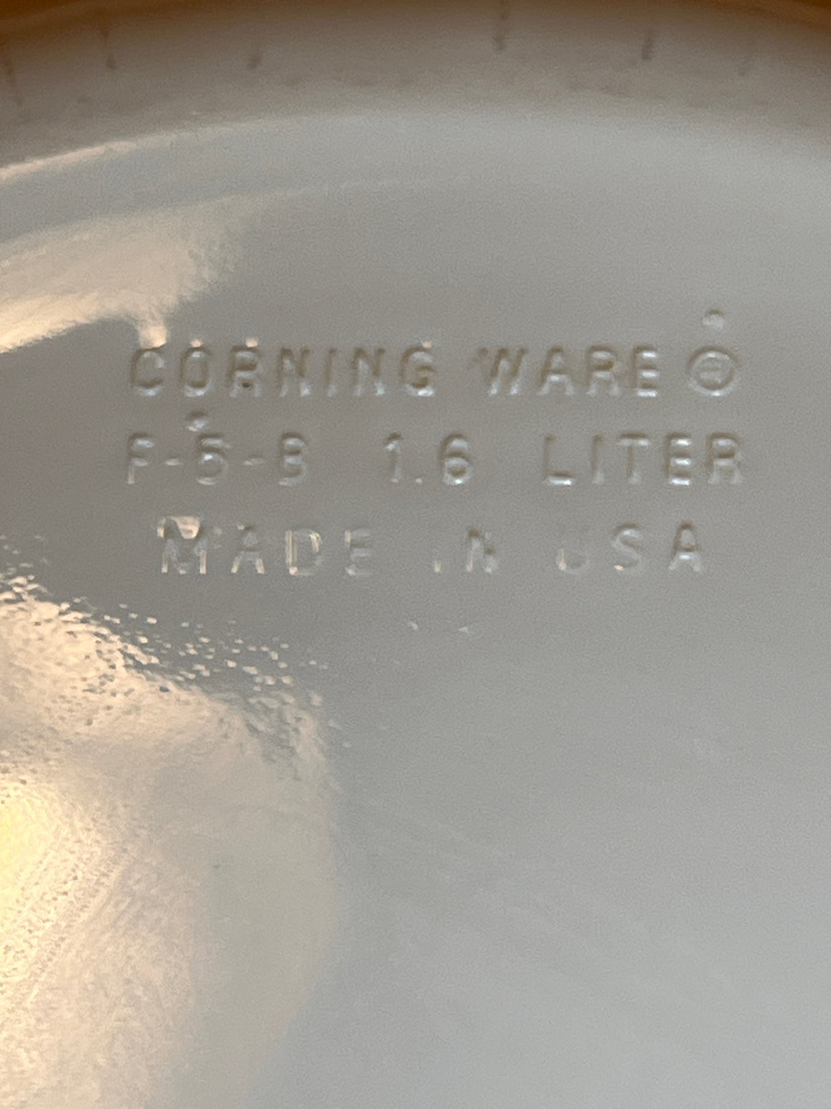 Corning Ware F-5-B 1.6L casserole dish underside, showing stamped details: CORNING WARE, model F-5-B, 1.6-liter capacity, MADE IN USA.