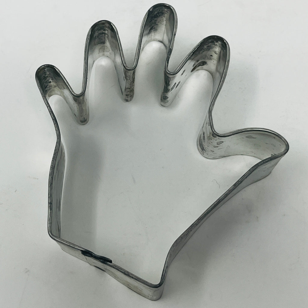 Mid century metal cookie cutter in hand shape, bird shape, and more, including Pillsbury's Comicooky Cutter from the 1930s.