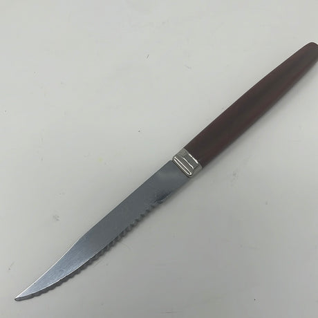 A serrated Regent Sheffield knife with a groovy Bakelite handle, ideal for slicing tomatoes with precision.