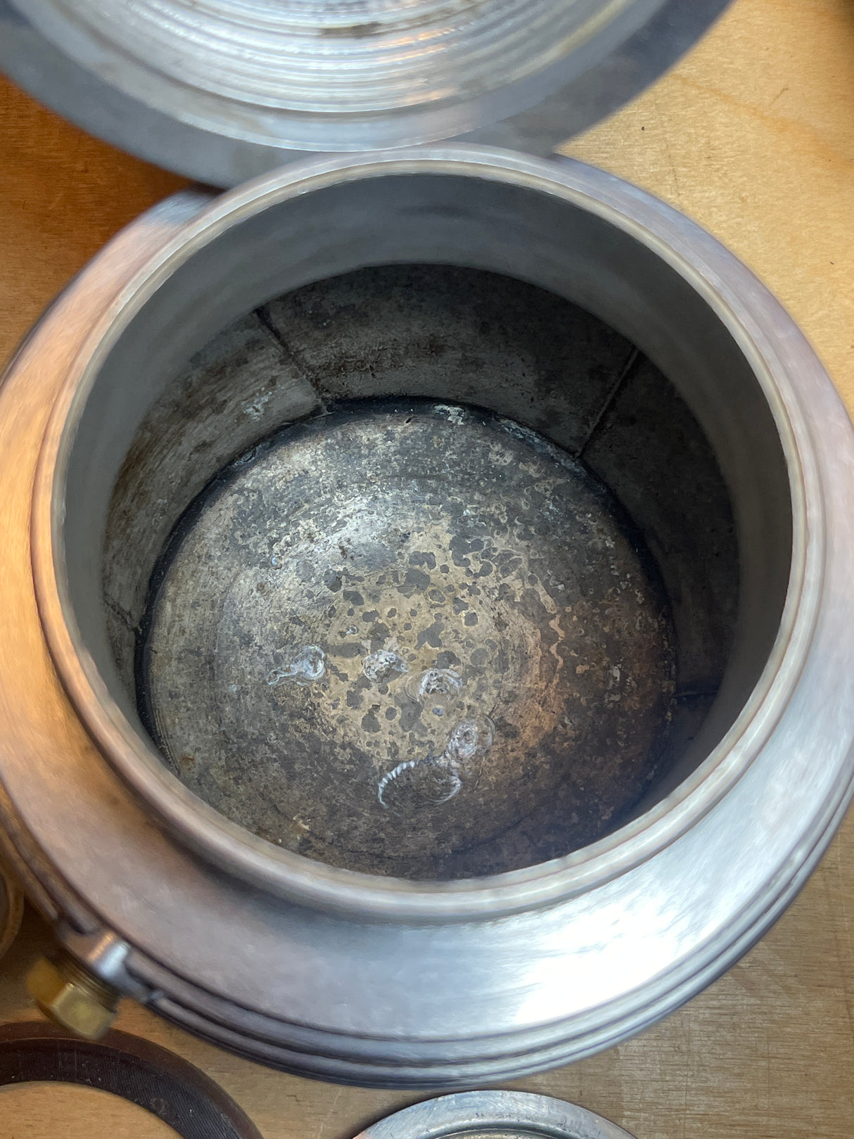 Close-up of the RARE Alessi Pulcina 6-cup moka pot, showcasing the interior corrosion and seam, with the gasket beside it.