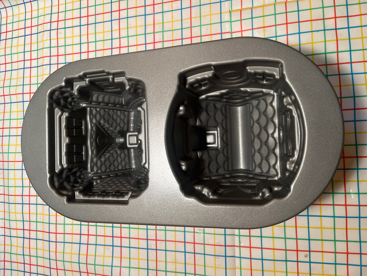 Gingerbread House Duet cast aluminum baking pan mold by Nordicware, featuring two detailed castle cavities, ensures even baking and easy release with a nonstick, PFAS-free finish.