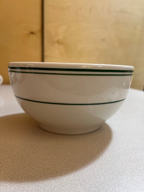 Homer Laughlin China collection features plates, bowls, saucers, mugs, and a creamer, showcasing elegant, timeless designs ideal for enhancing any dining experience.