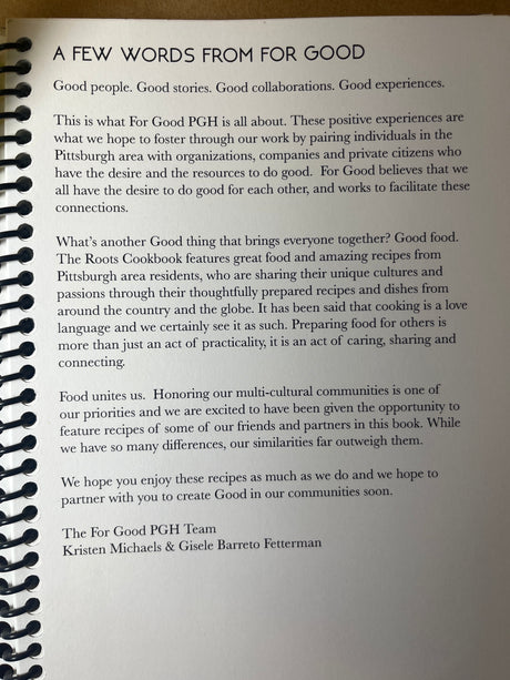 Spiral-bound Roots Cookbook page with a For Good PGH note detailing their mission of community connection through cultural recipes, signed by Kristen Michaels & Gisele Barreto Fetterman.