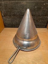 Vintage aluminum cone sieve strainer with a handle, ideal for large batch preparations. Features tiny perforations and a small dent at the cone tip.