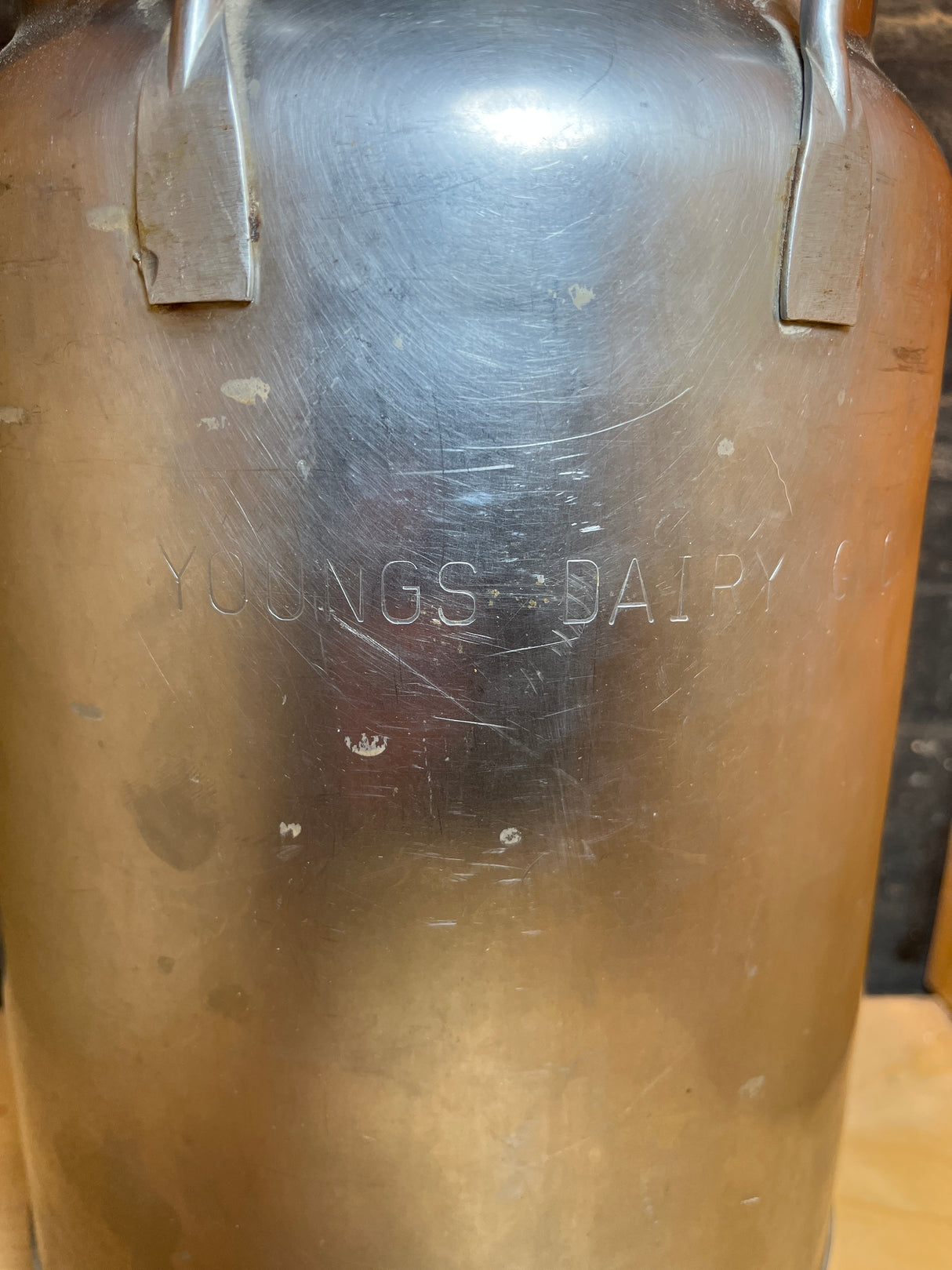 Vintage John Wood Young’s Dairy stainless steel milk can, featuring classic design with “YOUNGS DAIRY CO.” stamp, reminiscent of traditional dairy milk storage and transport vessels.