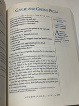 Page from Moosewood Restaurant Cooks at Home showing Garlic and Greens Pizza recipe with crust options, ingredients, preparation steps, nutrition info, and serving details.