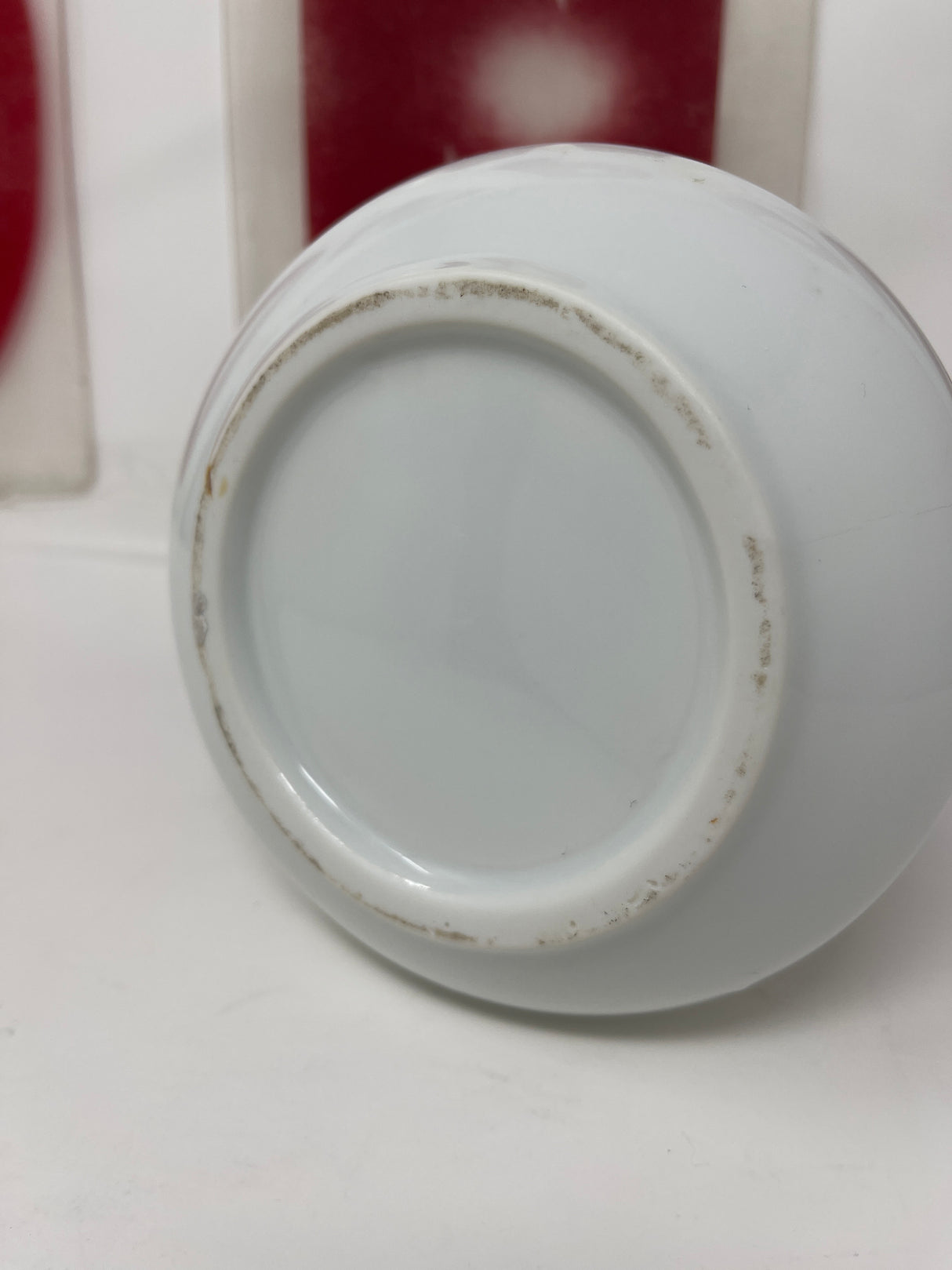 White ceramic pitcher holding approx. 32 fluid ounces, shown on a white surface. Features a tiny black spot inside but is in overall great condition.