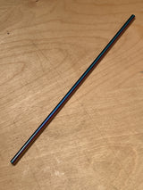 Stainless steel reusable drinking straw with an iridescent finish, placed diagonally on a wood-grain surface, showcasing its sleek, eco-friendly design.