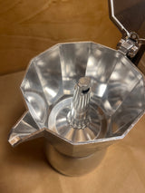 Interior view of La Cafetière Venice Aluminium 6-cup moka pot, showcasing the empty upper chamber and central funnel, highlighting its classic espresso-making design.