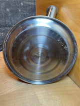 Underside of Farberware Whistling Tea Kettle, 2.5 quart, showing Farberware – Stainless Steel – Made in China stamp, indicating durable stainless steel construction.