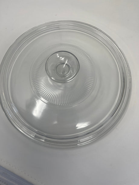 A versatile stainless steel sauté pan with a clear glass lid, ideal for heating smaller portions of food. Glass lid shown on a round base.