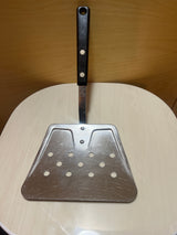 EKCO Flipper Lifter stainless steel spatula, triangular and perforated, with a sturdy black riveted handle, ideal for draining oil while flipping foods on a griddle.