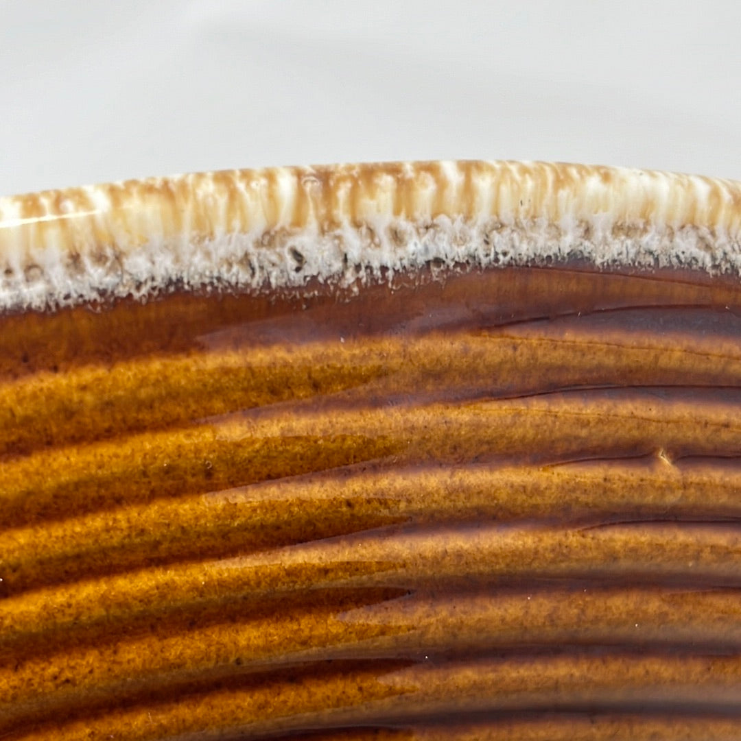 Close-up of Hull oven-proof oval plate with white and brown glaze along the rim. From Spoons Kitchen Exchange.