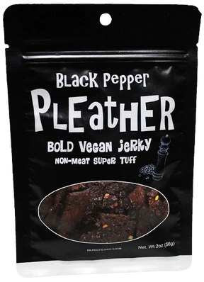 Pleather Vegan Jerky package with Black Pepper labeling, showing pepper-speckled strips through a clear window. Seitan-based, resealable 2 oz pack for on-the-go snacking.