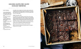 The Vegan Creamery cookbook spread featuring salted hazelnut brownies in a pan, topped with chocolate chunks and sea salt, beside a knife and salt bowl.