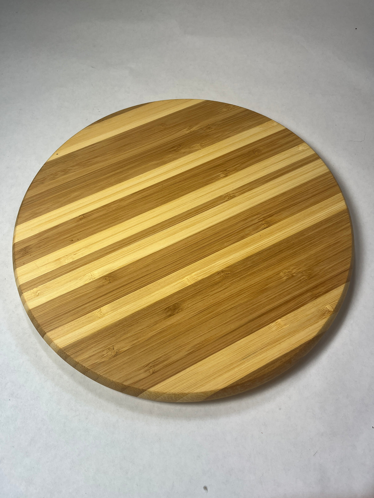 Circular wooden trivet designed to protect surfaces from heat damage caused by hot cookware, emphasizing its practical use and craftsmanship.